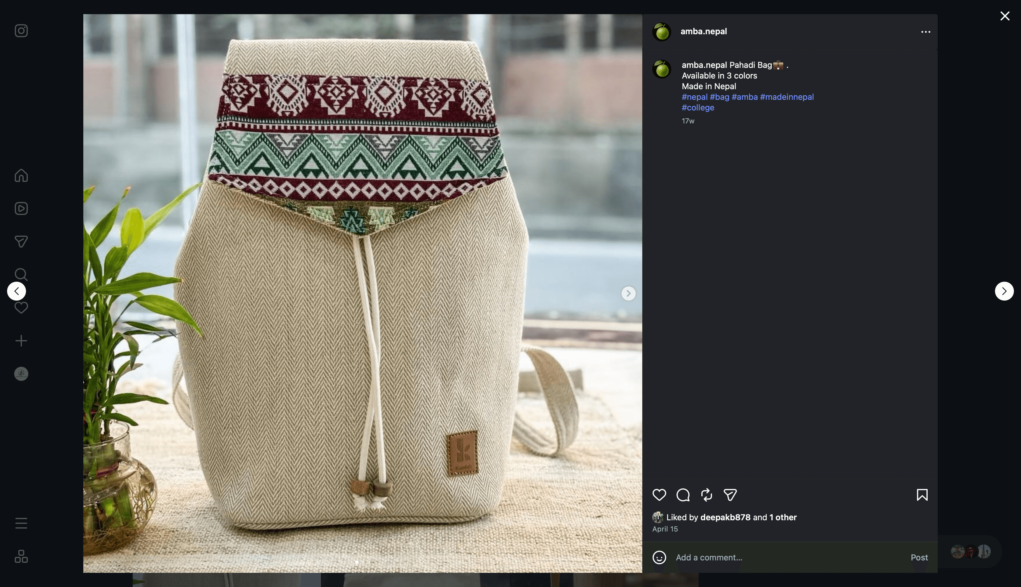 A natural herringbone hemp backpack with a crimson and green woven flap, on a wooden table